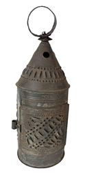 **SOLD** K1776 Small sized 19th century punched tin Lantern retaining original surface. Symmetrically punched and pierced patterned designs consisting of dots and dashes, along with circular holes in conical top for venting purposes. The hinged door opens freely for easy access to the interior candle socket. Attached round metal ring / handle at the top for carrying / hanging. Found in Pennsylvania. Measurements: 4 ½ diameter x 12 ½ tall with ring.  