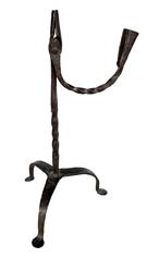 K91 18th century rare diminutive American twisted wrought iron rush light / candle holder with arched tripod base resting on hand forged padded feet. The candle holder acts as the counterbalance to hold the rush grips tight. Great original surface. Sturdy, sits level and is in wonderful working condition. Found in an Estate located in Wilmington, Delaware. Approximate measurements: 11 ½ tall and is 6 ¼ across feet.  