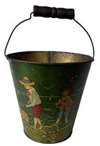 **SOLD** K191 Early 20th century Lithographed Tin Sand Pail with original wire bale and wooden handle. Prominently signed T Bros by the seam. (T. Bros was a maker of toys from Parsons, Pennsylvania in the early 1900s.) The pail is in good condition with a metallic sheen to the colorful scene depicting six children in Victorian style clothing  some are carrying pails / shovels, digging in the sand and one child is carrying a large basket of fish. Minor wear indicative of use. Circa 1900  1920s. Measurements: 6 ½ top diameter x 4 ½ bottom diameter. The sides are 6 ½ tall. Approximately 9 ¾ tall to top of handle. 