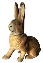 J50 Easter Candy Container - Flocked Rabbit in crouched position with right paw stretched forward. Circa 1940 Brown color, flocked surface, made of composite material with removable head and glass eyes. 