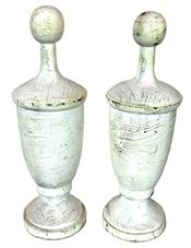 K1768 Pair of small size solid wooden architectural finials bearing several layers of white paint. Found in Pennsylvania. Each finial measures 3 ½ bottom diameter x 11 ½ tall.   