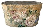 K132 19th century Philadelphia, Pennsylvania wallpaper Hat Box or Bandbox.  The outside of the oval pasteboard box bears remnants of wallpaper bearing a pastel floral pattern. The interior and bottom of this box is covered in newspaper dated 1858 from the Philadelphia, Pennsylvania area.  Measurements: 7 ½ wide x 4 ½ deep x 4 ¼ tall 