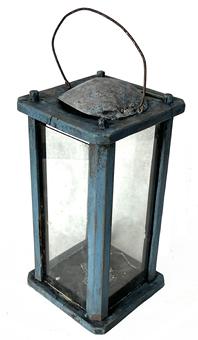 **SOLD** K199 19th century Pennsylvania original blue painted wooden Lantern featuring four bubbled glass panels contained within a wooden pinned and post construction frame with chamfered corner posts. One of the glass panels has a small notch cut into the bottom so it can be slid upwards for access to the internal metal candle socket. A wire bail handle is attached to the top for carrying / hanging purposes and a primitive metal hood covers the ventilation hole to protect it from wind / rain.  The wood is pine. Circa 1870s. Measurements:  5 x 5 x 9 ½ tall (approximately 12 ¾ tall to top of handle)  