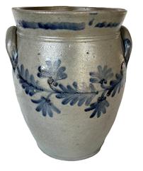 K164 19th century cobalt blue decorated Stoneware Crock attributed to Remmey of Philadelphia, PA. Ovoid shape with tooled shoulder, decorated flared collar with squared rim and applied lug handles. Fantastic hand brushed Cobalt fan-shaped flowers and leaves encircle the crock along the shoulder. Circa 1840s-1860s. Hairlines to bottom. Measurements: 6 5/8 diameter (bottom) x 8 ½ diameter (top) x 12 tall   