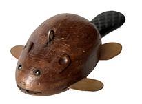 J343 Folk Art hand-carved wooden fishing decoy depicting a small Beaver. Solid wooden body with tin front/back legs. Detailed shaping to the body, tail, head, and ears. Very realistic carved details on the tail, original painted surface and glass inset eyes. Metal weight embedded in the underbelly. From a Wappinger Falls, NY collection.  Approximate measurements: 4 7/8 long x 2 ½ wide x 1 ¼ tall