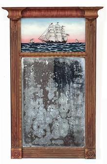 J292 Early 19th century Federal style Mirror featuring a hand-painted reverse painting of three tall-masted ships on the ocean/sea. The center ship bears several pennants and an early US flag flying proudly from its masts. The sturdy, solid wooden frame features detailed moldings, reeded sides and medallion corner blocks and bears its original pumpkin and yellow painted and decorated surface. Original mirror remains intact. Circa 1810. Measurements: 15 wide x 23 tall. 2 7/8 deep at top corners x 1 ½ deep at bottom corners.