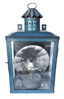 **SOLD** K1657 19th century large glass and tin Lantern with smoke ventilator chimney, large round reflector and clear glass hinged door for access to the fuel chamber inside. Lantern bears its original teal blue painted surface. Sturdy wire bail handle on top for carrying purposes and original tin brackets on back for mounting to a wall or post. Measurements: 10 ½ wide x 8 ½ deep x ~20 ½ tall with handle up.  