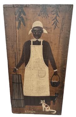 K1808 Folk Art oil painting by Arthur E. Glazier (East Berlin, Pennsylvania, 1928-2015) depicting a black Lady with very detailed facial features wearing a long-sleeved work dress, apron and head scarf with two loyal cats by her feet. She is standing by a butter churn, holding a basket of eggs with ears of corn, peppers and herbs shown hanging from drying racks suspended from the ceiling.  This wonderful artwork is hand painted on a reclaimed wooden typeset tray and is prominently signed A. Glazier at the bottom. Measurements:  16 ½ wide x 1 ¼ thick x 32 ¼ tall.   