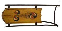 W59 ANTIQUE PAINT DECORATED CHILDS SLED. red and blue, yellow paint decorated top, Wrought iron runners. some wear to the paint  