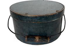 K1737 19th century New England Bail Handle Pantry Box with the original dry indigo blue painted surface. The overlapping bentwood sides are secured with small metal tacks. The sides of the Box are fitted with a pair of oval stamped tin handle mounts. Fitted with an arched wire swing handle with wooden hand grip bearing remnants of the original indigo blue paint. Natural patina interior. Measurements: 9 ¾ top diameter x 5 ¼ tall. 