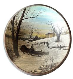 **SOLD** K1707 New England Folk Art painted wooden bowl with a hand painted Winter snow scene inside depicting a Man with his Two-Horse drawn sled full of logs in the foreground, and a house and fence in the background. From a collection in Vermont. Bowl has a lipped edge, shows evidence on the bottom of early slow lathe turnings and is out of round.  Small, tight age crack to edge of bowl. Measurements: 15 x 14 diameter x 3 ½ deep.  