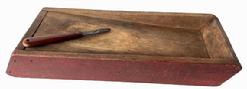 RM1482 Simplistic double-sided scrub / scouring box with great wear to one side and wonderful dry red paint. Slanted work surface on both sides. Tiny square head nail construction. Circa 1840s. (Knife included.) Measurements: 15 ½ long x 6 wide x 2 tall. 