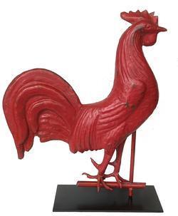 J23 Rooster weathervane, full-bodied copper and iron with original red painted surface. Dates to the second half of the 19th century. Circa 1870. Mounted on custom base for display purposes. Approximate measurements: 18 1/2" long x 4" wide. Mounted height is 22 1/2" tall. (Bottom of base measures 6" x 13 1/4").  One of the most enduring symbols in earlier America was the rooster. It was a dominant image for this countrys classic folk art including weathervanes, wood carvings and windmill weights.