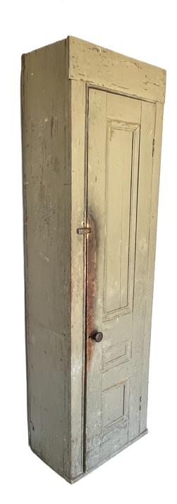 K1511 Early 19th century New England tall Chimney Cupboard in old okra colored painted surface. Cupboard features a fully mortised and pegged single door that opens to a natural patina interior with shelves for storage. Each shelf bears plate grooves on three edges. Applied molding is attached to the sides of the door opening and surrounds each of the three panels on front of door. Great wear and patina from years of use. Circa 1820-1840s. Measurements: 25 ½ wide x 14 ¾ deep x 84 (7) tall. The door is a solid 1 ½ thick.  