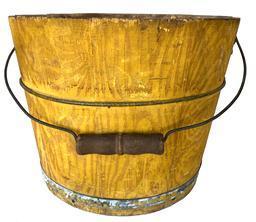 G236 A mid to late 19th century paint decorated bucket from Lancaster County, Pennsylvania. Arched wire bail handle with turned wooden grip. The interior is old natural patina, exterior painted with an overall grained mustard color over a yellow ground having a distinct and unusual diagonal tendril-like combed decoration. Two iron bands secure the staves. In generally good condition having minor imperfections commensurate with age and use. Measurements: 12" diameter x 9" tall.