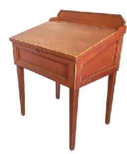 K33 19th century Pennsylvania Schoolmaster's Desk with slant lid and gallery resting on tapered legs bearing original dry red painted surface. Spectacular workmanship is evident throughout, especially in the molded panel details on the front and sides as well as the applied molding edges to the gallery and lid. The lid opens to reveal a clean, natural patina interior with two slanting shelves. Square head nail construction. Circa 1860s  1880s.  Measurements:  30 wide x 22 deep x 31 tall (front) x 38 ¾ tall (back). Apron to floor measures 21 5/8 tall.  The one board back is 16 1/8 wide.   