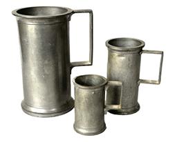 **SOLD** K200 Set of three 19th century heavy pewter graduated measures with handles. All three are double hallmarked by their handles.  Measurements:  Smallest one is 2 1/8 dia. X 3 ½ tall. Middle one is: 2 ¾ dia. X 5 1/8 tall. Largest one is:  4 dia. x 7 tall.