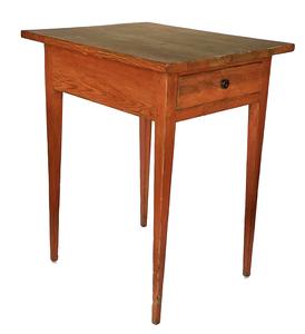 18th century Maryland pumpkin painted Hepplewhite one drawer table boasting long, delicately tapered legs and one dovetailed drawer. Rosehead nail construction with the apron of the table being mortised into the legs and secured with wooden pegs. A distinctive pinwheel carved into each outer side of the drawer is visible when the drawer is removed. Great size and height! Measurements: 21 wide x 25 deep x 30 ¼ tall. (24 from apron to floor)