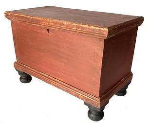 RM1473 Charming identified and dated Pennsylvania miniature blanket chest retaining original red and black painted surface with clean, natural patina interior. The chest boasts a dovetailed case with applied molding around lid and bottom and rests on turned feet that are mortised through the bottom. Inside the lid is stenciled prominently in pencil with M.F. 1844 and N.M.F., 1874  and there are what appears to be several names (unreadable) and dates less prominently written both on the inside of the lid and on the bottom of the chest. This miniature chest bears such great characteristics that would be appealing to sit alone and admire all by itself or add to a stack. Measurements: 13 ¾ wide x 7 ¼ deep x 9 ½ tall   