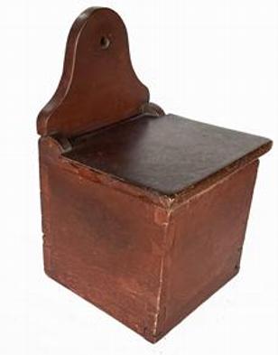 B637 Early 19th century Pennsylvania Salt Box with the original red paint. Dovetailed case featuring an arched back with hole for hanging. The wood is walnut. Circa 1820.