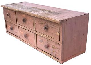 J202 Late 19th century Pennsylvania Country Store counter six-drawer apothecary retaining the original salmon painted surface. Very faint remnants of blue painted writing that once identified drawer contents remains on some drawers. Square head nail, one-board construction with solid ends and original knobs. Clean, natural patina drawer interiors. Measurements: 42 wide x 14 ¼ deep x 15 tall