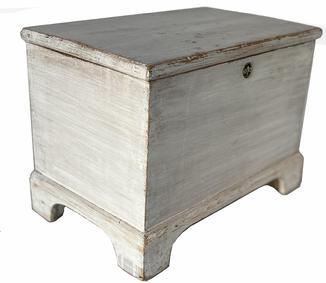 H933 Mid-19th Century Lancaster County, Pennsylvania miniature blanket chest with applied bracket base in original white painted surface. Clean, natural patina interior. T nail construction.