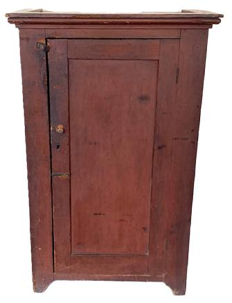 K137 Wonderful early 19th century Pennsylvania one door cupboard in original red painted surface featuring cut out feet, applied molding around the top and a panel door that is fully mortised and pegged. Clean interior with sturdy shelves for storage. Square head nail construction. Circa 1810s-1820s. Measurements: 30 ¼ wide x 16 deep x 48 ½ tall (Case measures 27 ¼ wide x 14 12 deep).    