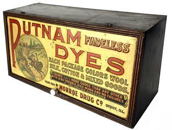 J192 General Store Advertising display cabinet for Putnam Dyes. This double-sided display cabinet is made of wood with colorful panels on the front and back. The door lifts to reveal an instructional label that identifies how to achieve popular shades made by mixing Putnam fadeless dyes.. The front panel graphic is tin and both the back and interior advertisements are paper labels adhered to the wood. The panels display a Trademark graphic of General Putnam on horseback being chased by British Redcoats. The Putnam Fadeless Dyes were made by the Monroe Drug Co. in Quincy Illinois. Circa 1920s. Measurements: 21 wide x 10 tall. Top is 7 deep and tapers to 8 ½ deep at the bottom.