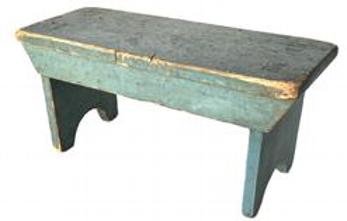 **SOLD** K1719 Early 19th century Lancaster County, Pennsylvania mortised stool boasting its original blue painted surface. The legs are double mortised through the top and end in half-moon cut out feet. Each side is adorned with a tapered end drop apron that is mortised into the legs. One board pine wood with tiny wire nail construction. Measurements: 14 long x 5 ½ wide x 6 ½ tall.  