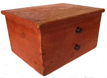 F690 Early Pennsylvania wooden Chamber Pot Cabinet in original dry red paint. Sturdy dovetailed case with hinged lift lid to hide the chamber pot.  A slightly recessed circle carved inside the bottom was intended to secure the pot, while the raised inner bottom board placed the pot in the correct height for appropriate use.  Inner seat supports are still present however the seat is missing.  There are inscribed lines along the front to imitate faux drawers, complete with two wooden knobs. This would make a great addition to a primitive bedroom setting! Measurements: 18 1/2 wide x 14 deep x 10 tall