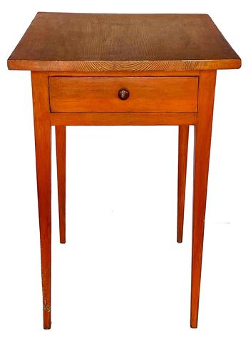 G915 18th century Maryland pumpkin painted Hepplewhite one drawer table boasting long, delicately tapered legs and one dovetailed drawer. Rosehead nail construction with the apron of the table being mortised into the legs and secured with wooden pegs. A distinctive pinwheel carved into each outer side of the drawer is visible when the drawer is removed. Great size and height!  Measurements: 21 wide x 25 deep x 30 ¼ tall. (24 from apron to floor)