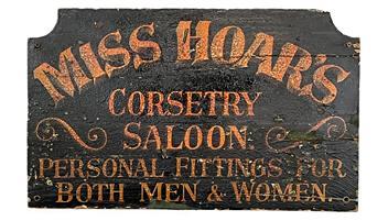 RM1546 Wooden Trade Sign advertising "Miss Hoar's  Corsetry  ~ Saloon ~  Personal Fittings For Both Men & Women".  All hand painted on single board with shaped top corners. Single sided. Measurements: 24 ¼ wide x ¾ thick x 14 ¾ tall