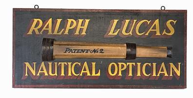 J321 Hand painted New England Trade Sign advertising Ralph Lucas Nautical Optician with applied wooden replica of a No. 2 telescope. Measurements: 23 3/8 wide x 10 ¾ tall x 5/8 thick. (The applied wooden replica telescope measures 1 1/8 thick x 17 ¼ long x 3 1/8 tall.)