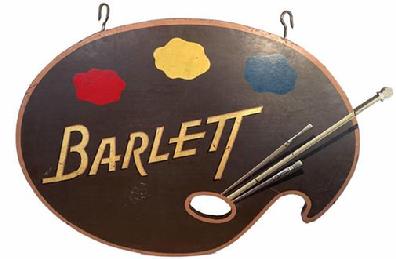 E70 mid-20th century Wooden Trade Sign for Barlett art Supplies Circa 1940s: Unusual and well done wooden trade sign for "Barlett " . Collectors of trade signs will appreciate the talented brush work and typographical flair this sign maker exhibited. Note how the brush was made and applied to the back of the sign A[O1] metal band was applied to the outside edge to reinforce it on both sides. With its original iron hooks for hanging