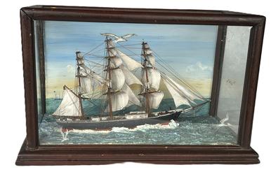 **SOLD** K1729 Fantastic historical Folk Art Ship Diorama depicting the Clipper Ship Flying Cloud out of New York (1851-1874) in full sails upon rough seas.  The back panel of glass bears hand painted clouds and a beautiful sky and reverse painted birds adorn several areas on other panels of glass. Phenomenal details abound throughout the model. Cased measurements: 15 3/8 wide x 8 deep x 9 ½ tall.  