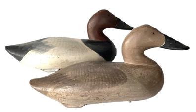 Q475 Pair of Paul Gibson Canvasback Decoys. Circa 1950's from Have de Grace, MD.  The initials "S.J." are painted in red on the bottom of each decoy. The original weight, staple, and rings remain intact on the bottom of each decoy. 