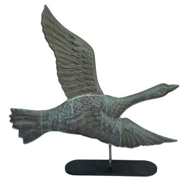 **SOLD** K1783 Early 20th century full body copper Goose Weathervane depicting a Goose in flight with raised wings on one side and tucked legs / feet on the reverse. Very nice example mounted on a metal base for display purposes. Great craftsmanship and details. Approximate measurements:  24 ½ long x ~1 ¼ thick x 23 ½ tall. The base is 4 wide x 14 long.  