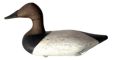 K143 High head Canvasback Drake Decoy by Havre de Grace, Maryland carver Bob McGaw (1879-1958).  Original staple, ring, and weight intact on bottom. Surface bears multiple layers of old working paint with original painted surface showing in some areas. 