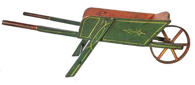 J48  Late 19th century Child's wheelbarrow in original green and bittersweet painted surface with yellow paint decoration. Wheel is constructed of an iron band over wooden spokes and turns freely. Great size for display! Nice wear. Circa 1900. Measurements: 35 ½ long x 11 ½ wide x 11 tall