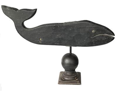 K183 Early 20th century New England Folk Art Wooden Whale Weathervane with original black painted surface. Hand-hewn solid wooden body with metal eyes. Mounted in a turned wooden base for display purposes.  Approximate measurements:  ~27 ½ long x ~1 ¼ thick x ~9 ¾ tall.  Overall mounted height is ~19 ½ tall.