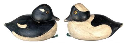 **SOLD** K30 Pair of Bufflehead decoys  original surfaces with glass eyes and original weights intact on bottoms. The attached tag reads:  Attributed to carver Jim Van Brunt of Seatauket, NY (1902-1978). All original. These decoys were gunned over on Long Island Sound in the 1950s. Rare decoys as only a few were made for this diminutive and fishy tasting duck. Made of native white pine. Each decoy measures approximately 9 long x 4 ½ wide x 5 tall.