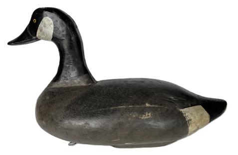 K1638 Branded Canada Goose Decoy carved by James A. Currier (1886  1971) of Havre De Grace, Maryland.  Branded B on bottom (Dr. Brendle Rig of Havre De Grace, MD). Surface bears original painted surface. Original staple and weight intact on bottom.  