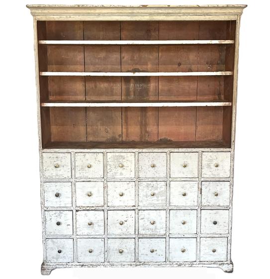 K1789 Spectacular late 18th century  early 19th century Pennsylvania open-top flat wall apothecary cupboard bearing its original white painted surface. Very unique form features open shelves bearing their original red wash interior above 24 drawers resting on an applied bracket base. Applied molding surrounds the top and double beaded edges adorn the shelves and drawer dividers. T nail construction. The wood is pine. Circa 1790-1800. Measurements: 50 ¼ wide x 12 ½ deep x 66 tall. 