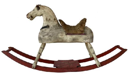 F170  19th century hand made wooden Rocking Horse in it's original paint showing wonderful wear from lots of love, the rockers are painted red with a black and mustard decorated platform. Early in the 19th century, woodworkers, most from New England, started making more sculptural horses. "These were hand-made, "It was Dad in the woodshop cranking out the first ones. . While almost always made of wood, some were padded and others had leather or cloth saddles and reins, features that have often been lost to time. Measurements are: 46" long x 10 1/2" wide x 25" tall