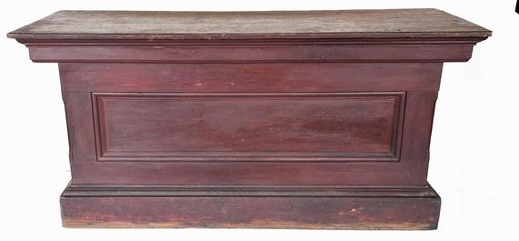 J277  19th century New England  6' store Counter, in original red  paint , from a  Country store in Maine . with one single panel in the front, and ends, two board top. It has a nice applied  molding, all square nail construction. The back is open to reveal a single shelf for storage,   Measurements:  72 wide x 27 ½ deep x 33 3/8 tall