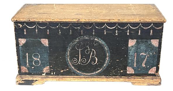 **SOLD** K69 Early 19th century New England original blue painted and decorated pine blanket chest with the date 1817 painted on the front, along with the initials SB in Period script lettering.  Hand painted swag and tassel decorations adorn the front and sides. Clean, natural patina interior with open top till and beautiful original strap hinges. Dovetailed case with dovetailed applied bracket base. Applied molding secured with T nails and early square head nails surrounds the lid. Measurements: 41 ¼ wide x 19 ¼ deep x 19 ½ tall.    