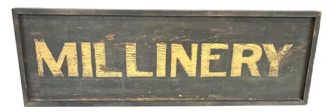 J44 Mid-19th century New England wooden Trade Sign advertising "Millinery". Letters are painted in gold on a black background. Single sided, one board surrounded with applied molding secured with small wire nails. Circa 1870s.