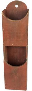 K1777 Early 19th century Pennsylvania original red painted double wall box / pipe box featuring curved pocket openings with tapered edges and an arched back with hole for hanging purposes. Small square head nail construction. The wood is pine. Measurements: 5 5/8� wide x 4 3/8� deep x 21 7/8� tall. 