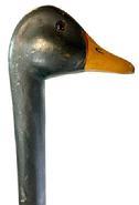 L474 19th century Folk Art Carved Walking Stick / Cane with carved Duck Head as the handle.  The head is painted a dark green with glass eyes and a mustard and black painted bill.  Nice patina over entire surface. Carved from a single piece of wood. Measurements: Overall length is 36 &frac14;� with the head being 4 &frac34;� deep at bill x 1 &frac12;� wide x 2 &frac12;� tall. 