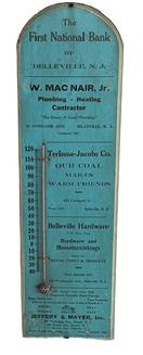 **SOLD** M120 Historical very early 20th century wooden thermometer Advertising �The First National Bank of Belleville, N.J.� and other local vendors in Belleville NJ including �W. Mac Nair, Jr. Plumbing - Heating Contractor�, �Terhune-Jacobs Co.� Coal Dealers, �Belleville Hardware � S.H. Neve, Prop. � Agents for Devoe Paints & Products� and �Jeffery & Mayer, Inc.� for �Fireproof Portable Steel Garage�. Maker in lower right corner is �Wm. Nagel�. N.Y. City�. This fantastic advertising piece retains its original blue and white painted surface with black lettering. (Note: The First National Bank of Belleville, NJ opened in 1906.) Measurements: 7� wide x 1� thick x 24� tall.  